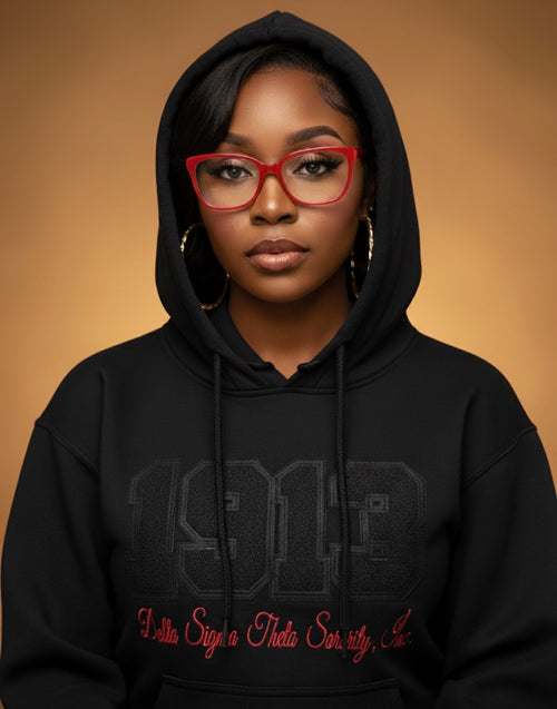 Person wearing a black hoodie with text on a brown background